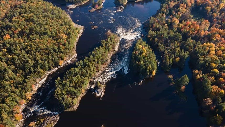 Aerial view of Ottawa river rapids in autumn foliage.