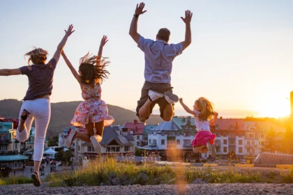 Family enjoying sunset jump in Mont Tremblant village.