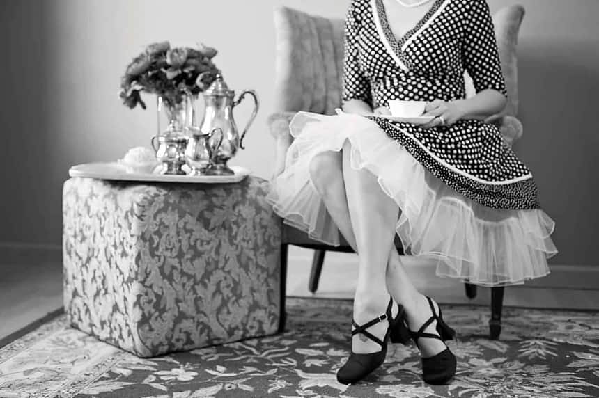 Elegant vintage tea party attire and setting.