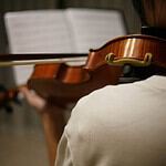 Violinist performing at Coldplay tribute concert in Edmonton.