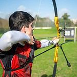 Archer practicing at outdoor archery range.