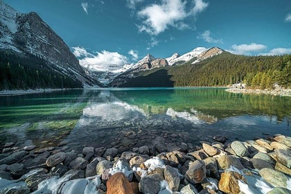 Scenic Canadian lake with turquoise waters and mountain landscape.