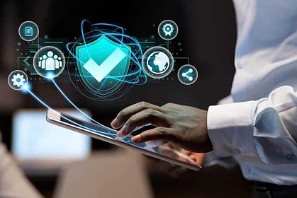 Person using tablet with cybersecurity and data protection icons.