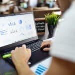 Person learning Excel on laptop for online skills improvement.