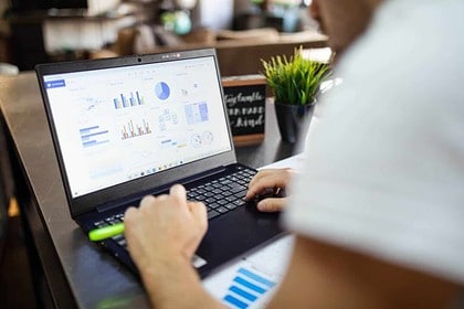Person learning Excel on laptop for online skills improvement.