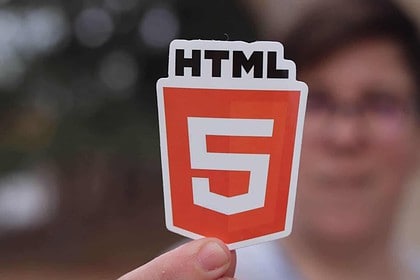 HTML5 sticker held up with a blurred background.