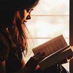 Woman engrossed in studying a language book.