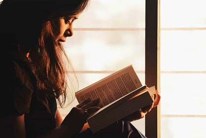 Woman engrossed in studying a language book.