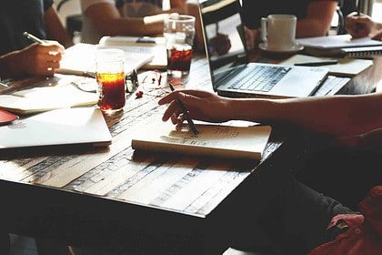 Entrepreneurial team discussion at a startup workspace.