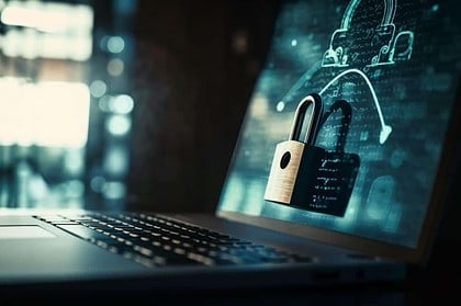 Cybersecurity concept with padlock hologram on laptop.