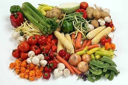 Assorted fresh vegetables on a white background.