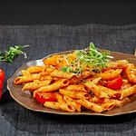 Delicious penne pasta with tomato sauce on a plate.