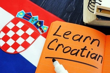 Croatian language learning materials with flag and notebook.
