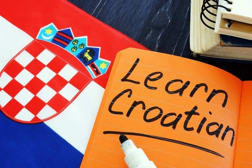 Croatian language learning materials with flag and notebook.