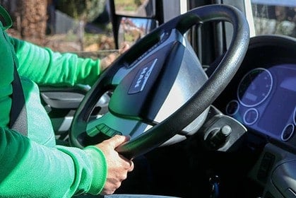 Person learning to drive a semi-truck cabin.
