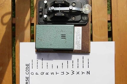 Morse code transmitter and alphabet guide for learning.