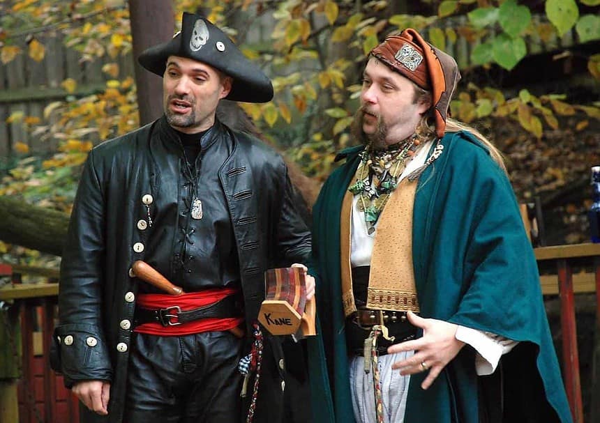 Men in pirate costumes at a Renaissance fair.