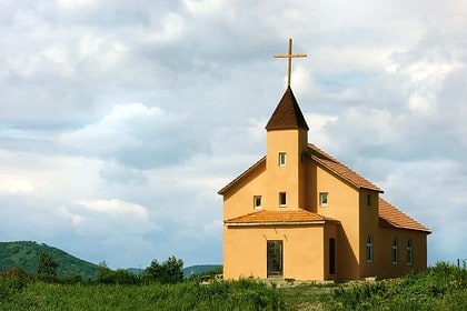 Scenic rural church against cloudy sky