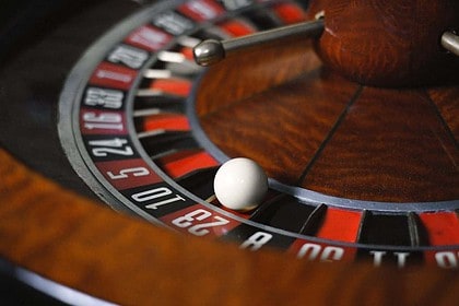 Close-up view of a casino roulette wheel with ball.