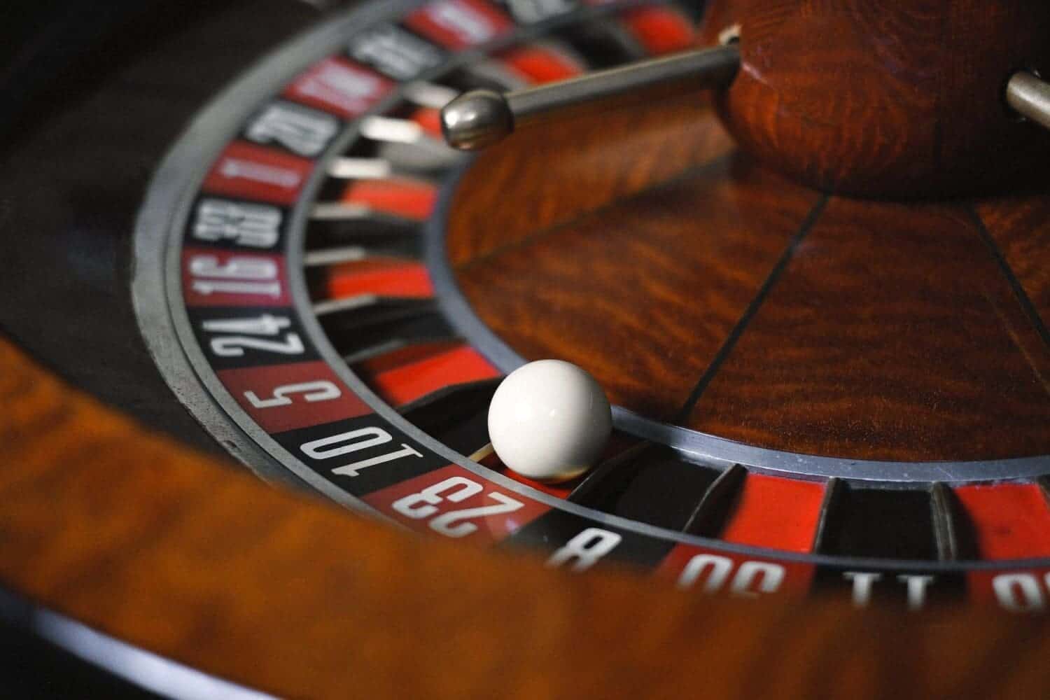 Close-up view of a casino roulette wheel with ball.
