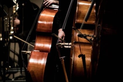 Cello player in ambient candlelight setting in Toronto.