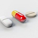 Assorted dietary supplement pills on white background.