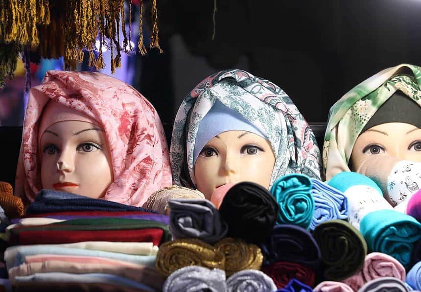 Colorful Moroccan textiles and headscarf mannequins.