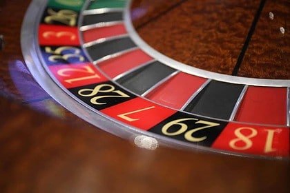 Close-up view of casino roulette wheel with ball.