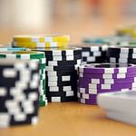 Assorted poker chips on a gaming table.