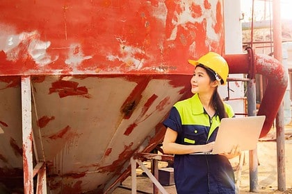 Engineer inspecting machinery in industrial setting