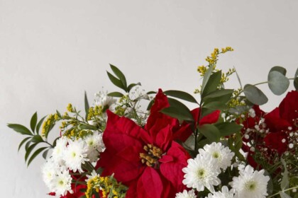 Red and white floral Christmas centerpiece with poinsettias.