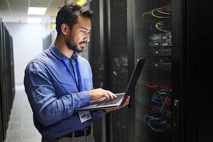 IT professional configuring servers in a data center.