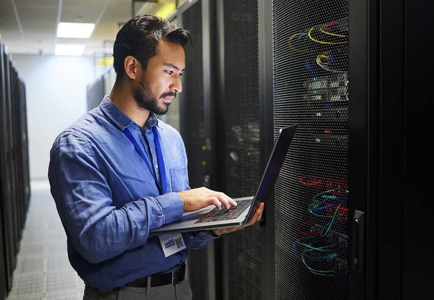 IT professional configuring servers in a data center.