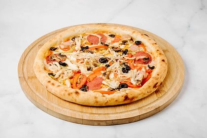 Pepperoni olive pizza on a wooden serving board