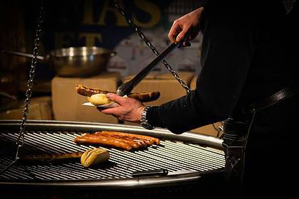 person cooking brats