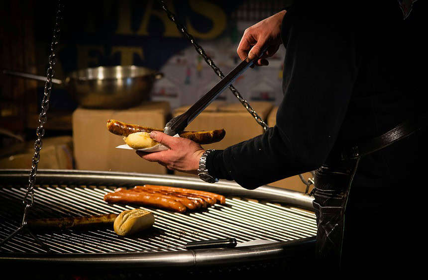 person cooking brats